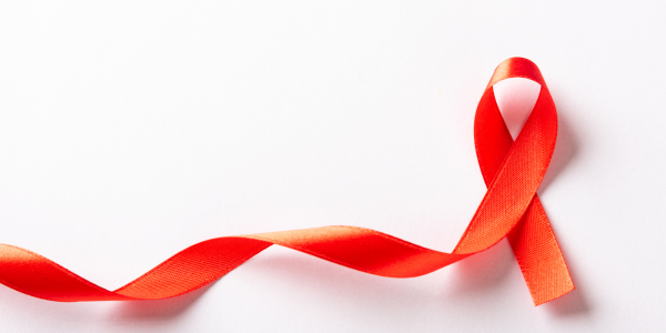 A red ribbon on a white background. The red ribbon is a symbol for AIDS / HIV.