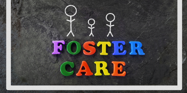 The word foster care is written in fridge magnets