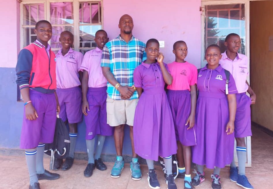 A group of school children standing and posing for the camera