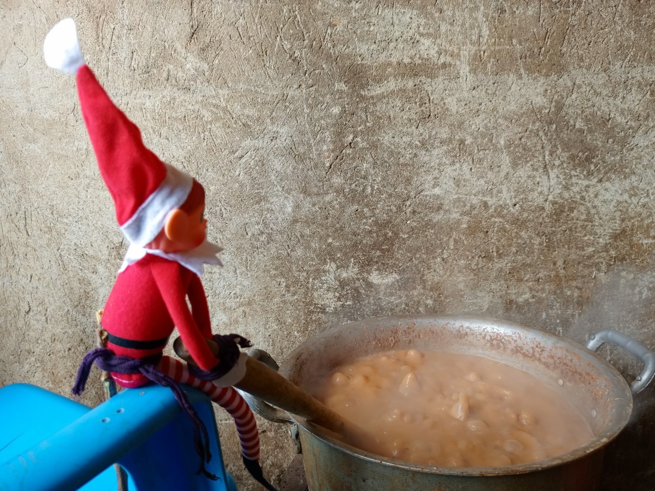 An elf toy mixing a bubbling pot of food
