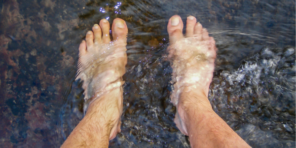 close up of feet in water
