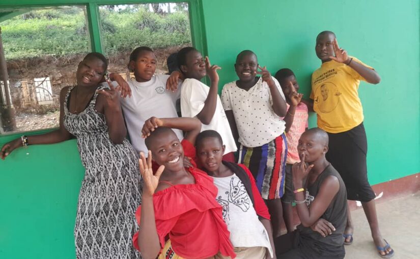 A group of street connected girls posing and smiling for the camera