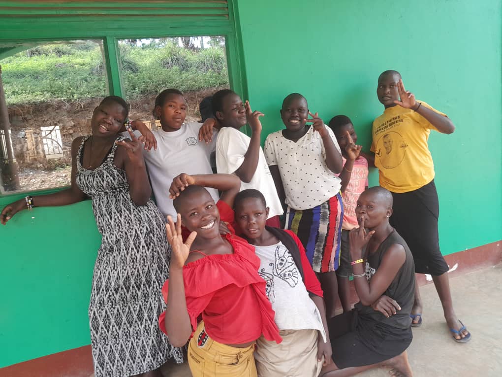 A group of street connected girls posing and smiling for the camera