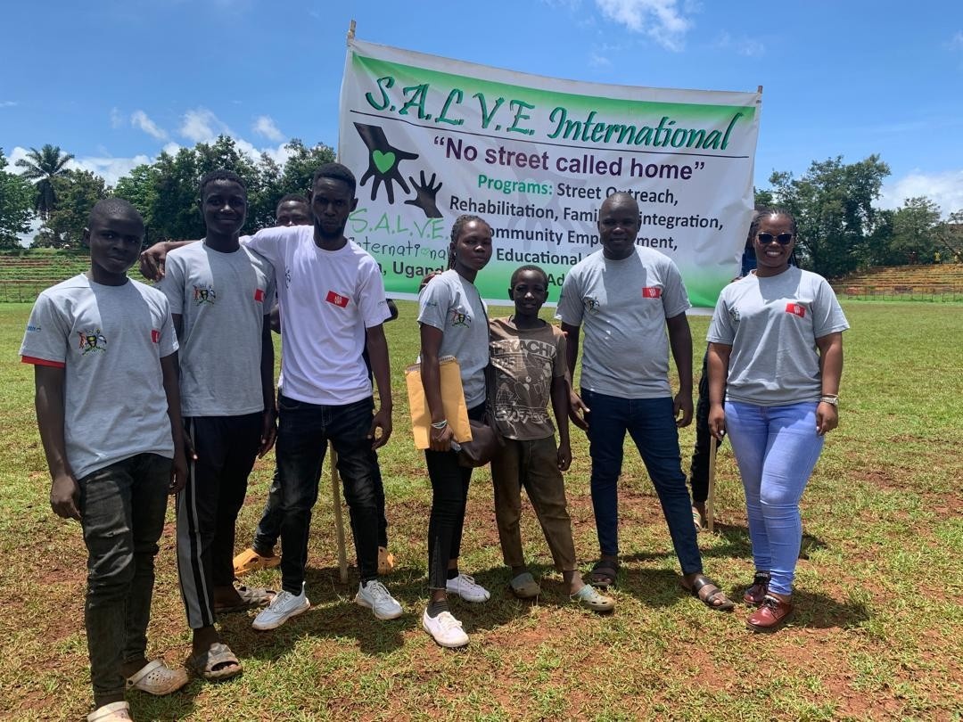 group posing in front of a SALVE International banner