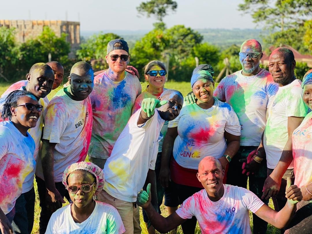 SALVE staff members posing for the camera after completing a colour run. They are all dusted in bright colours.