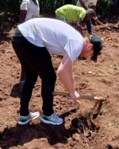 SALVE's CEO Lucas, sewing seeds into the ground in Uganda